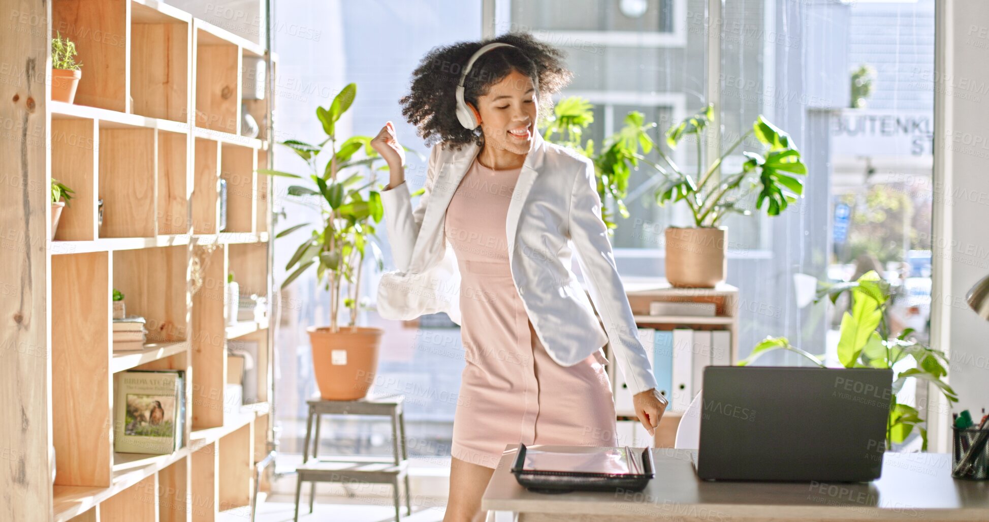 Buy stock photo Music, dance and a business woman in her office in celebration of success, goals or a target at work. Freedom, energy and headphones with a happy young employee listening to audio or sound on stream