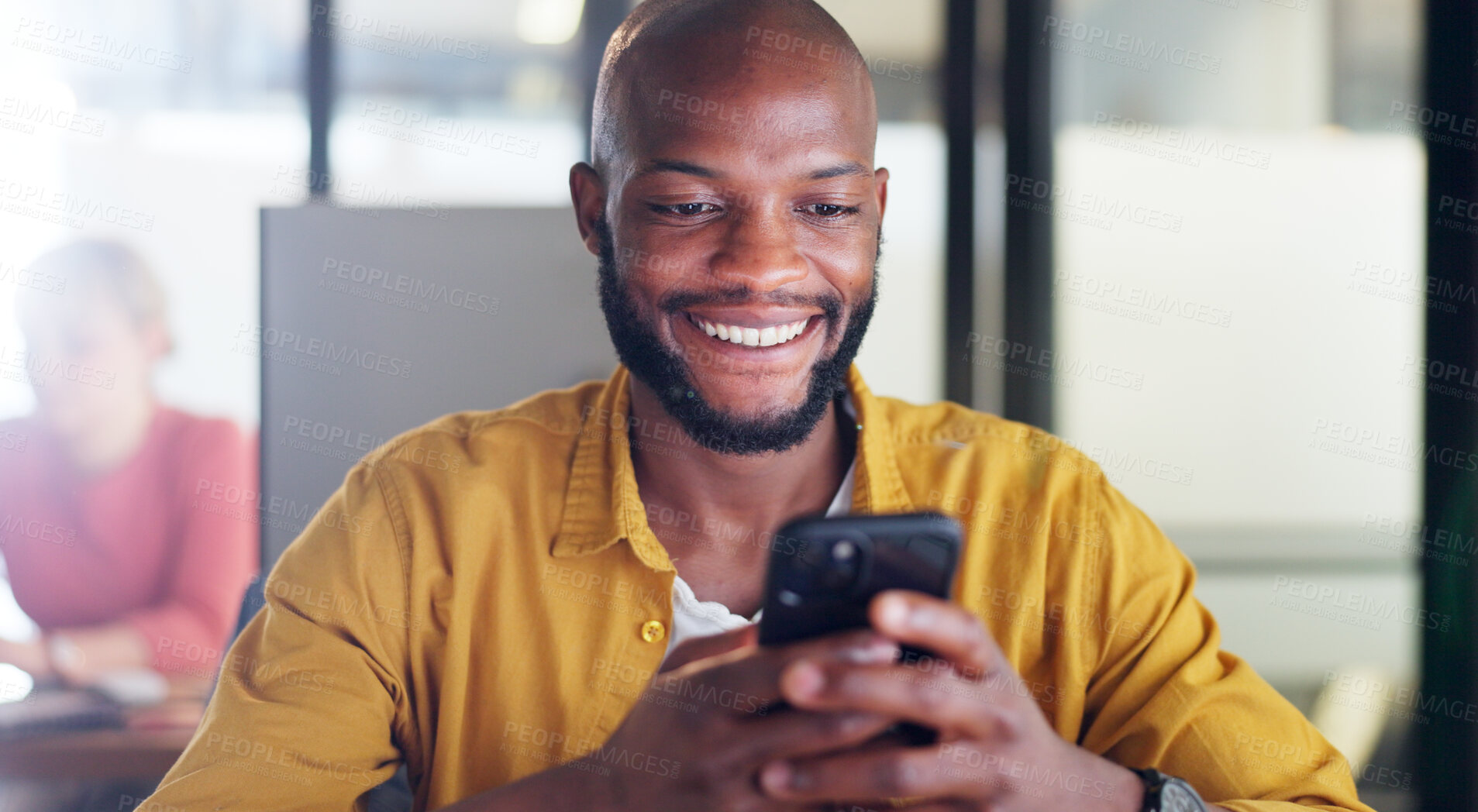 Buy stock photo Phone, smile and black man in the office typing a text message on social media or mobile app. Happy, networking and African male designer browsing on the internet, online or website with cellphone.