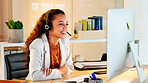 A happy modern business woman having an online meeting at her computer. A cheerful worker talking during a corporate teamwork seminar. A female accountant on a company web conference at her desk.