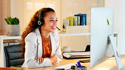 A happy modern business woman having an online meeting at her computer. A cheerful worker talking during a corporate teamwork seminar. A female accountant on a company web conference at her desk.