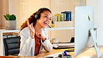 A happy modern business woman having an online meeting at her computer. A cheerful worker talking during a corporate teamwork seminar. A female accountant on a company web conference at her desk.