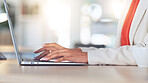 Female lawyer writing a report on a laptop at a corporate law firm. Professional paralegal or attorney typing legal advice and drafting digital business emails to clients with an online software app