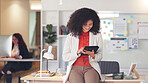 Cheerful, smiling and happy black business woman browsing on a digital tablet in a modern office. Portrait of confident entrepreneur feeling ambitious and motivated for success while planning online