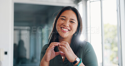Asian woman, face and smile with hands in heart shape, emoji or love gesture for creative career at the office. Portrait of happy Japanese woman employee designer smiling with heart hands in startup
