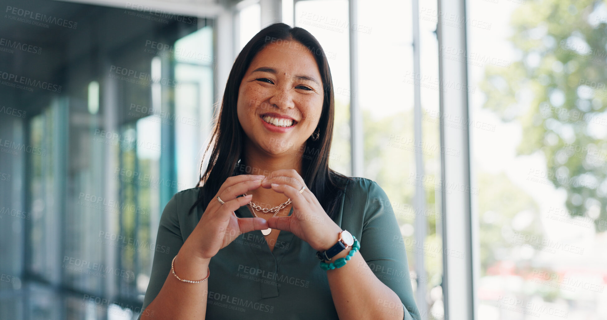 Buy stock photo Heart, hands and portrait of Asian woman in office by window for career, job and opportunity. Creative agency, professional and face of business person with emoji for company pride, support and love