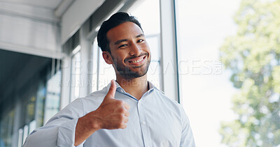Businessman, thumbs up and wink while walking in office for success, motivation or thank you. Face portrait, yes and male employee from Singapore with hand gesture for support, like emoji or approval