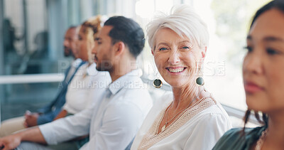 Face of a business woman in a meeting with people for office motivation, success and planning at a corporate company. Executive, ceo or worker smile in portrait at a workshop, seminar or conference