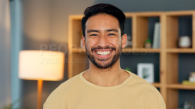 Face of a happy male interior designer. Portrait of a young confident entrepreneur or trendy real estate agent looking confident and smiling after styling a living room with a new modern design