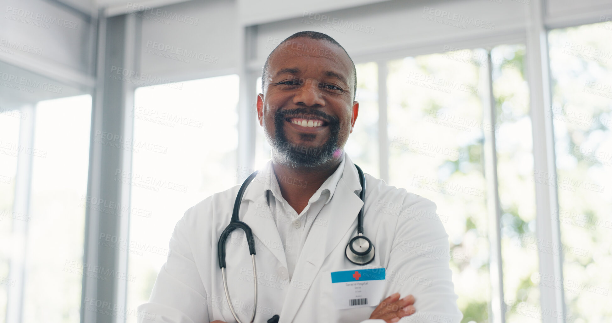 Buy stock photo Healthcare, portrait and man doctor with arms crossed at hospital for consulting, help or friendly service with a smile. Happy, face and African surgeon at a clinic for medical, solution or treatment