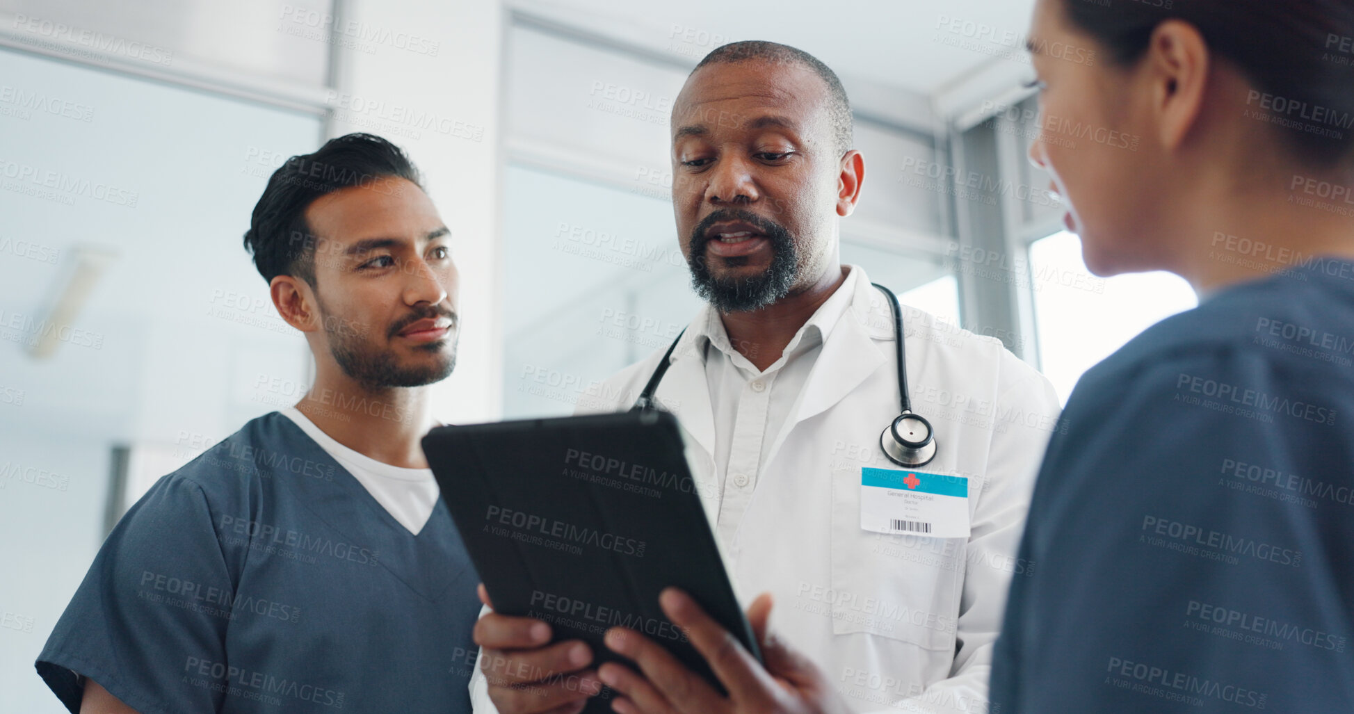 Buy stock photo Doctor, tablet and nurses in meeting, research or planning surgery in teamwork or results at hospital. Black man, medical or healthcare professional with technology talking to staff on schedule plan