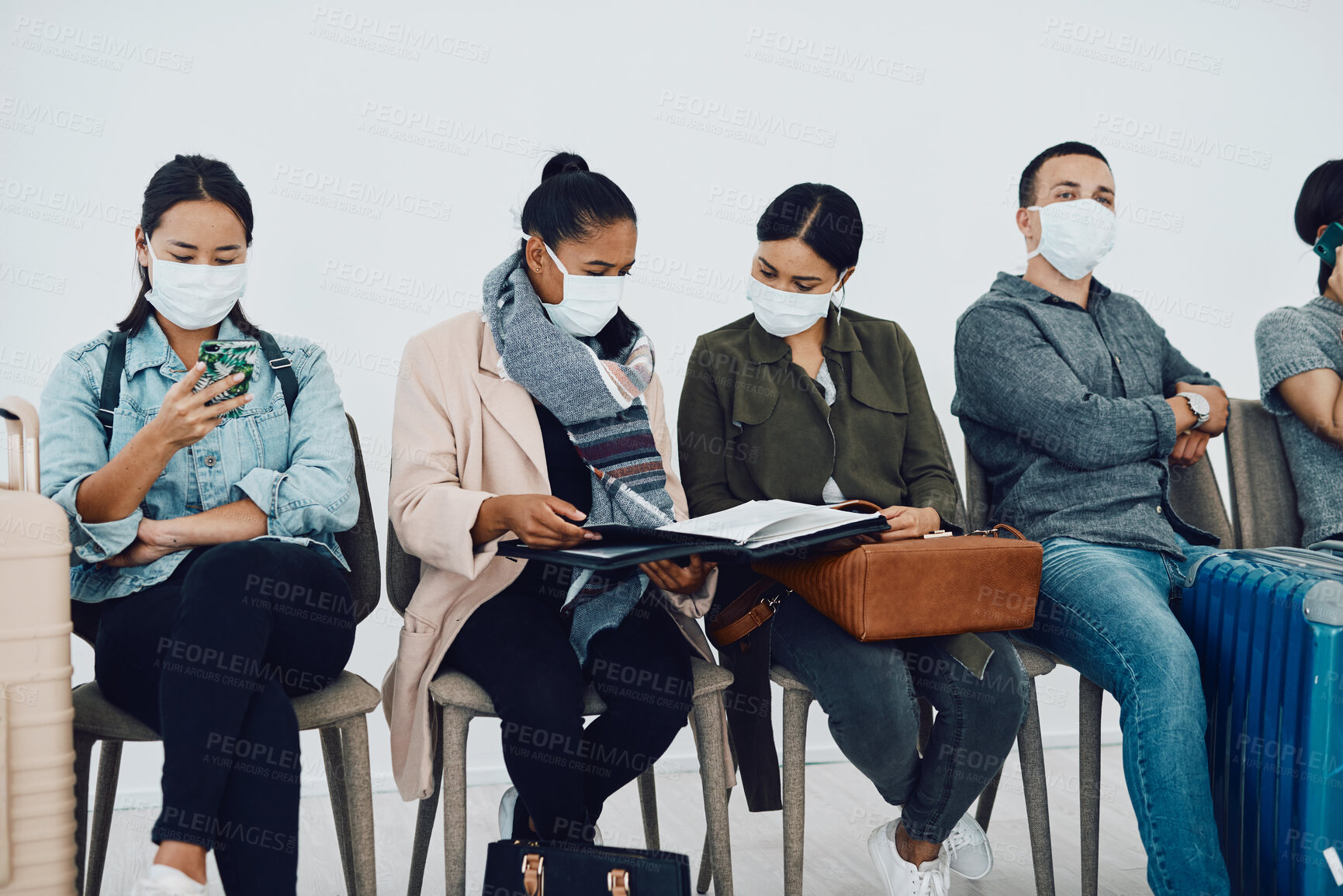 Buy stock photo Immigration during covid with people traveling and waiting at an airport lounge during the pandemic. Foreign refugees in a public travel facility or border wearing masks in a corona virus outbreak
