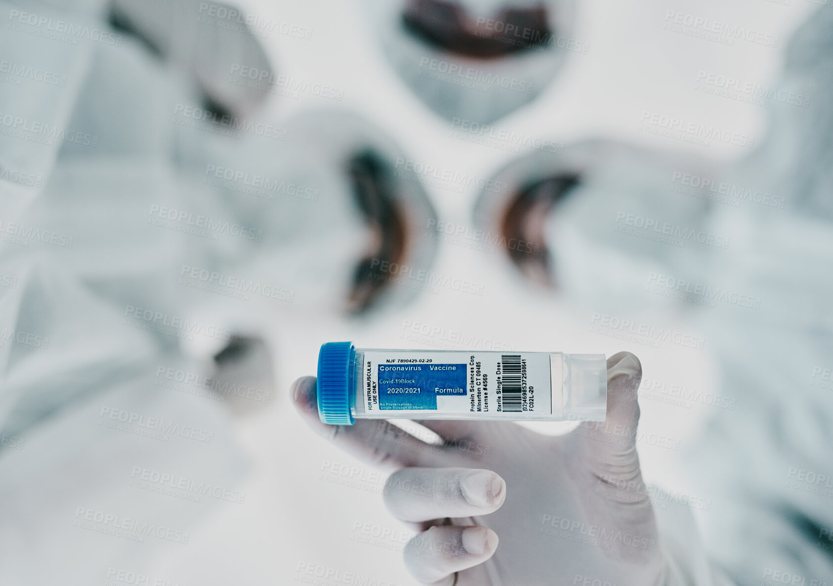 Buy stock photo Healthcare scientists holding a vaccine, test tube and medical treatment while doing covid research in a laboratory. Group of science technicians standing together with the cure for corona virus