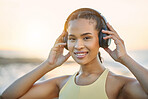 Fitness, music or happy woman at beach for running training, exercise or workout at sunset in Brazil. Portrait, sports athlete or healthy girl runner listening to podcast or radio audio in headphones