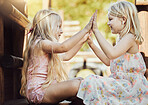 Children, pattycake and summer with a friends or sisters playing a game outdoor in a park together. Kids, high five and family with girl siblings having fun or bonding outside on a jungle gym