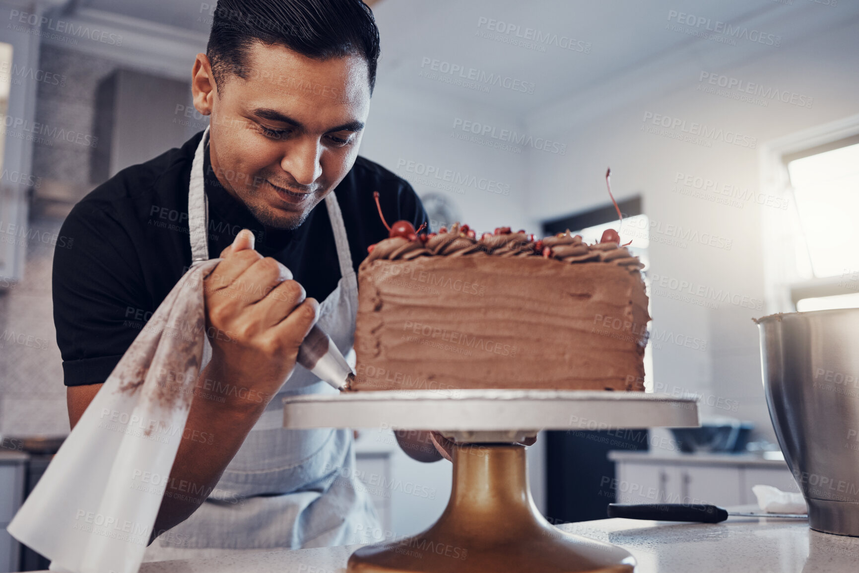 Buy stock photo Piping, bakery and chef baking a cake with chocolate and pastry in a kitchen and is happy decorating his recipe. Food, dessert and cook preparing a sweet meal by a Brazil man and adds cream