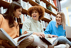 Friends, students in library with books for education, university group of women, funny and studying together. Laughter, diversity and young, research for paper or exam with motivation and reading