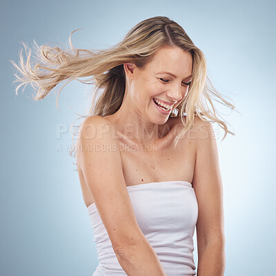 Buy stock photo Beauty, wind in hair and laugh with a woman in studio on a gray background enjoying a skincare joke. Facial, cosmetics and funny with an attractive young female laughing for natural treatment