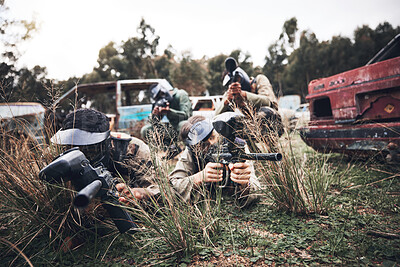 Buy stock photo Paintball, team and camouflage waiting in grass for sneak attack, aim or practice with guns. Group of soldiers in extreme sports, teamwork or coordination in hiding for strategic plan to win match