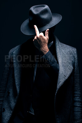 Buy stock photo Mystery, middle finger or dark man in stylish outfit, fashion or suit posing isolated against a studio black background. Person, style and fashionable male or gangster with offensive gesture