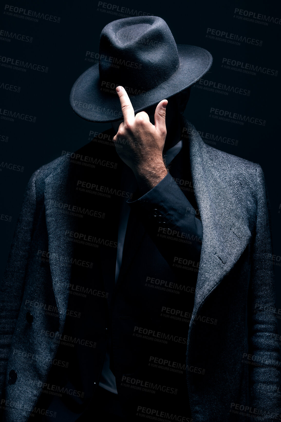 Buy stock photo Mystery, middle finger or dark man in stylish outfit, fashion or suit posing isolated against a studio black background. Person, style and fashionable male or gangster with offensive gesture