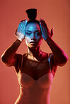 Portrait, fashion and neon with a model black woman in studio on a kaleidoscope background for beauty. Art, makeup and style with an attractive young female posing indoor for culture or cosmetics