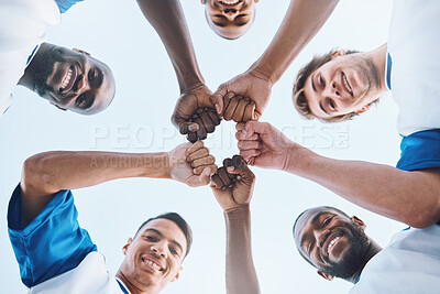 Buy stock photo Sports, teamwork and fist bump circle for soccer for support, motivation and community on field. Diversity, team building and low angle portrait of football players ready for game, training and match
