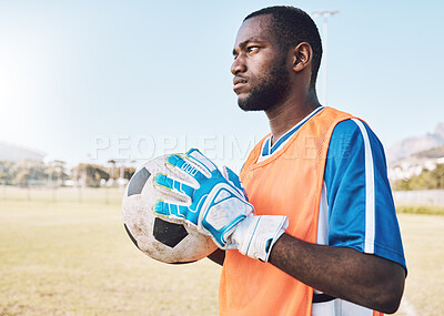 Buy stock photo Black man, football and goalkeeper training on field for focus, exercise or gloves for safety in sunshine. Athlete, soccer goalie and hands with ball, vision or mindset for workout, strategy or sport