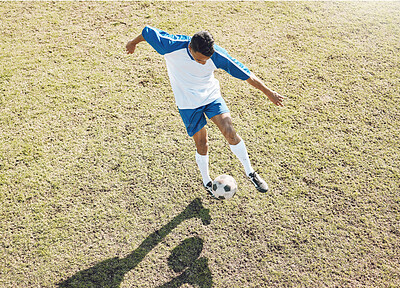 Football ball, soccer player and athlete doing sports cardio, training and exercise on a grass field. Kick, game and workout outdoor with fitness and running for wellness and health with energy