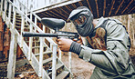 Paintball, man and gun with target, sport with fitness and battlefield challenge, war game and soldier outdoor. Safety helmet extreme sports and exercise, shooting range action and military mission