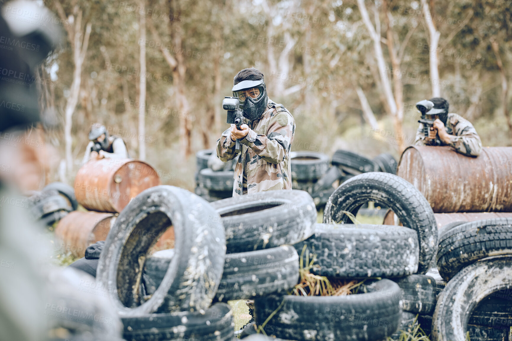 Buy stock photo Paintball, war or gun men in a shooting game playing or training with action on a fun battlefield. Mission focused, military or army team with weapons gear for survival in an outdoor competition