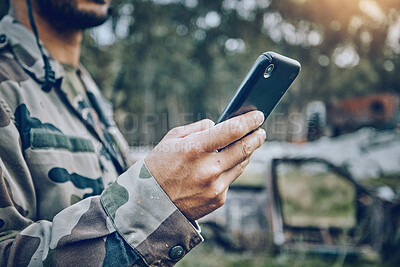 Buy stock photo Military soldier, mobile phone and communication while outdoor for connection, safety and security. Army person with a smartphone for social media, contact or chat on a field, boot camp or at war