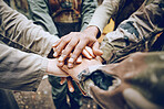 Military, team work or hands in a huddle for a mission, strategy or motivation on a paintball battlefield. Goals, collaboration or army people with support in a partnership or group of ready soldiers