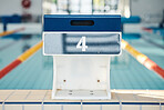 Sports, swimming and podium number by pool for training, exercise and workout for triathlon competition. Fitness, motivation and four on professional diving board ready for dive, start and race