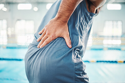 Buy stock photo Pain in back, sports and man by swimming pool with injury, muscle ache and inflammation from training. Health, medical care and male with accident, emergency or body bruise from fitness or exercise