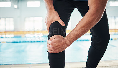 Buy stock photo Hands, knee injury and swimming instructor holding his joint in pain with a pool in the background of a gym. Fitness, coach and anatomy with a sports man suffering from a sore leg during exercise