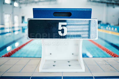 Buy stock photo Sports, swimming pool and number on podium for training, exercise and workout for triathlon competition in gym. Fitness, motivation and five on professional starting block for dive, start and race