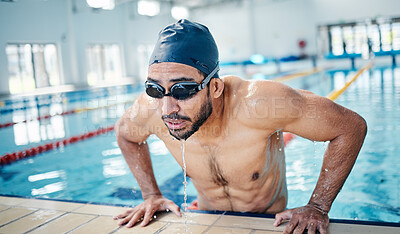 Buy stock photo Athletic, breathing and man swimming for fitness, training and race in a stadium pool. Tired, sports and face of an athlete swimmer doing cardio in the water for a workout, sport and competition