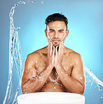 Water splash, face and man with basin for beauty, skin and skincare cleaning body and topless. Mexican, male and wellness model with moisture, cleanse and hydration isolated in studio blue background