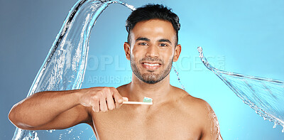 Buy stock photo Dental, portrait and man brushing teeth in water splash, studio and mockup on blue background. Oral, hygiene and male teeth model with brush for mouth, cleaning and whitening product while isolated