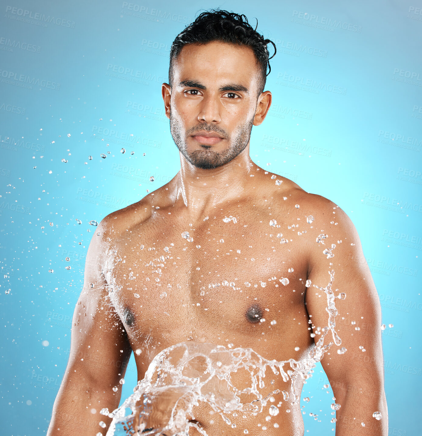 Buy stock photo Portrait, splash and beauty, skin and skincare man cleaning his body, muscle and topless. Water, male and wellness model with moisture, cosmetic and hydration isolated in studio blue background