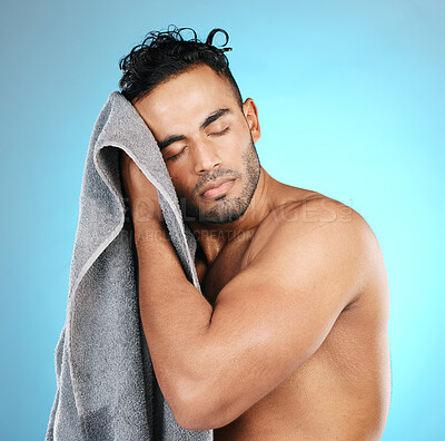 Buy stock photo Man, towel and dry hair in studio after shower, cleaning and washing for beauty routine on isolated blue background. Bathroom, haircare and male model relax with wellness, body care and grooming