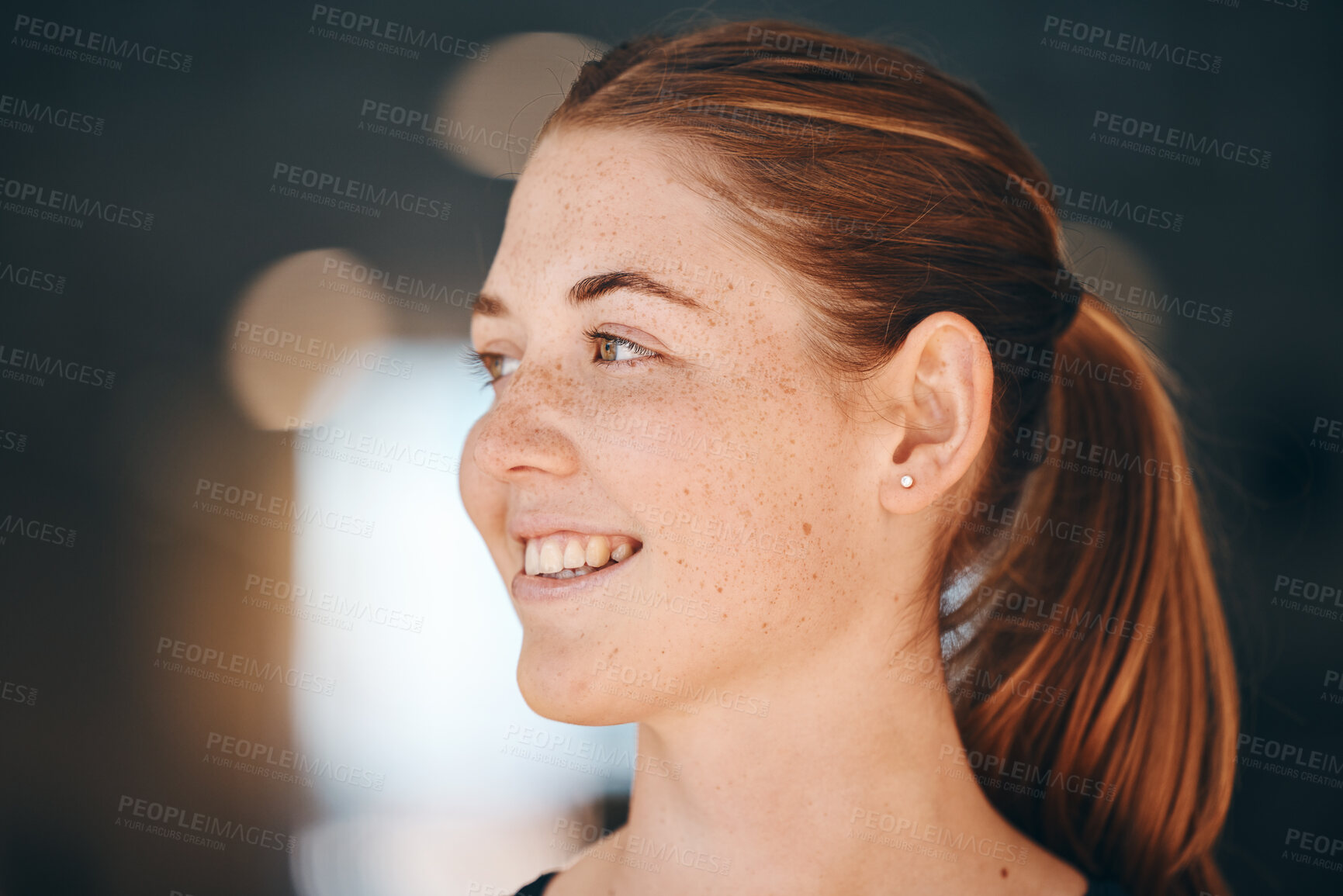 Buy stock photo Face, freckles and thinking with a redhead woman indoor feeling happy or positive about the future. Idea, ginger and carefree with an attractive young female standing alone on a dark background