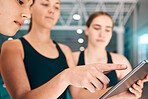 Young athletes looking at tablet, training data for sports with technology and group of people at indoor swimming pool. UX of digital workout, swimmers learning from teacher and performance analytics
