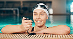 Time, exercise and girl with a watch for swimming, fitness and motivation in a pool. Check, sports and happy athlete reading a timer for workout, cardio and competition in the water for a race