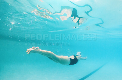 Buy stock photo Swimming, fitness and sports with a woman underwater in a pool for cardio or endurance exercise. Water, swimwear and health with a female swimmer during a workout or competitive watersports game