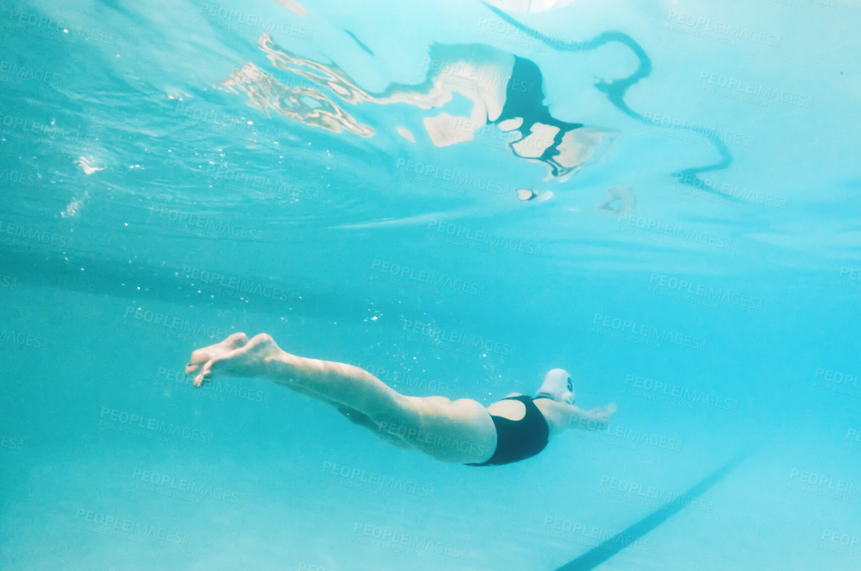 Buy stock photo Swimming, fitness and sports with a woman underwater in a pool for cardio or endurance exercise. Water, swimwear and health with a female swimmer during a workout or competitive watersports game