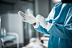 Hands, latex gloves and surgeon preparing for operation in a consultation room in the hospital. Healthcare, surgical and medical doctor ready for surgery in ER or emergency theatre in medicare clinic