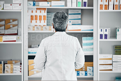 Buy stock photo Stock, back and pharmacist at a medicine shelf for healthcare, medical work and service at a pharmacy. Doctor, pills and pharmaceutical worker looking at the coice of drugs while working at a clinic