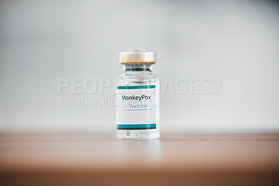 Buy stock photo Moneypox, hospital vaccine and bottle for healthcare, medical virus and cure for disease on a table. Health, care and vial of liquid for a vaccination, pandemic remedy and prevention at a clinic