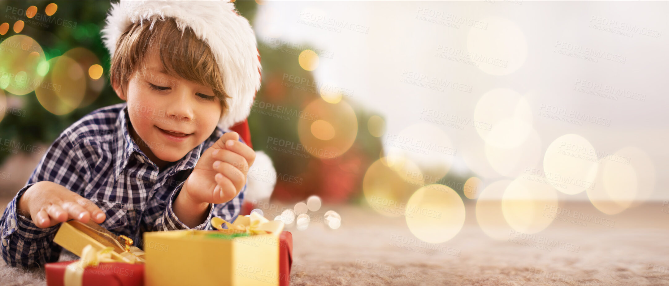 Buy stock photo Boy, child or opening christmas present on living room floor, house or home with mockup, bokeh or mock up space. Smile, happy or festive kid with gift box in celebration, holiday or tradition giving